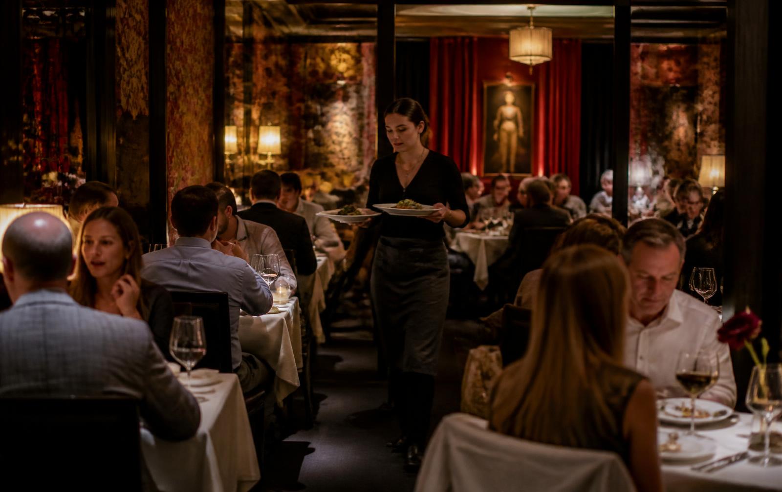Server working through a busy restaurant dining room